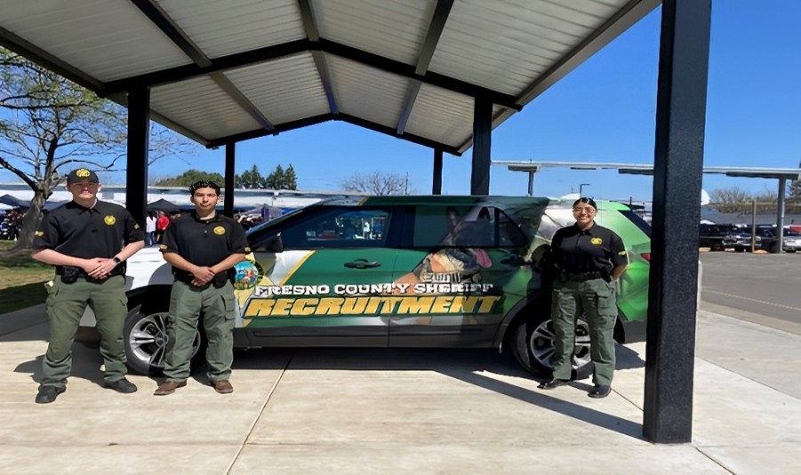 Academy Youth Holding Standing Near a Vehicle